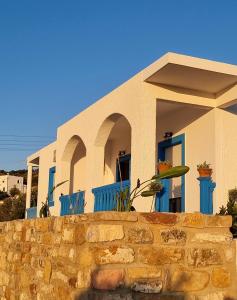 a house with a stone wall in front of it at Drymonas Sunset in Drymonas