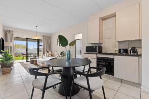a kitchen and living room with a table and chairs at Prime location in upmarket security estate in Johannesburg