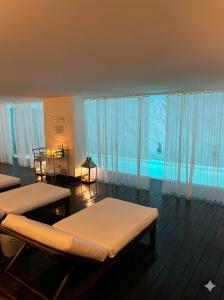 a room with two beds and a large window at Yoo Punta del este Deluxe in Punta del Este +107 photos