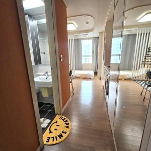 a room with a bathroom with a sink and a mirror at 부천역300m 코지하우스 in Sosa