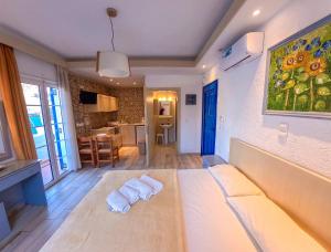 a living room with a bed and a kitchen at CALLIOPE MAILLE studios & apartments in Myrties
