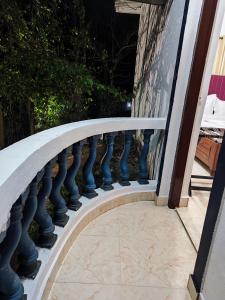 a curved railing on a balcony of a house at Quiet Coastal Hideaway Studio near Candolim Beach in Candolim