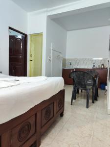 a bedroom with a bed and a chair and a desk at Quiet Coastal Hideaway Studio near Candolim Beach in Candolim