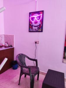 a room with a chair and a picture of a skull at Quiet Coastal Hideaway Studio near Candolim Beach in Candolim