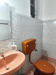 a bathroom with a toilet and a sink at Quiet Coastal Hideaway Studio near Candolim Beach in Candolim +6 photos