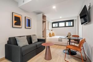 a living room with a couch and a table at Dobo Madrid Portugal in Madrid