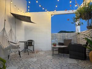 a patio with a hammock and a table and chairs at 2325 Apartaestudios in Arauca