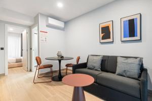 a living room with a couch and a table at Dobo Madrid Portugal in Madrid