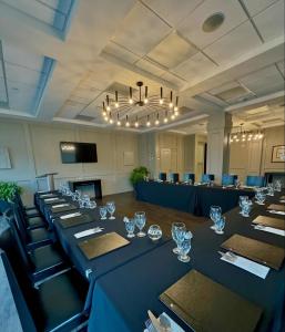 a large conference room with a long table with wine glasses at Hôtel Shediac in Shediac +42 photos