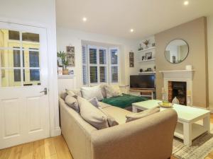 a living room with a couch and a table at Gordon Avenue in Camberley