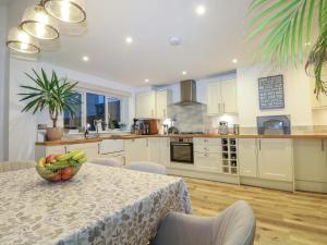 a kitchen with a table with a bowl of fruit on it at Gordon Avenue in Camberley