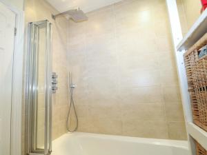 a bathroom with a shower and a bath tub at Gordon Avenue in Camberley +19 photos