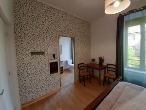 a living room with a table and a dining room at Gîte À l'ombre du pommier in Ruynes-en-Margeride +26 photos