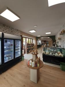 a grocery store with a counter and a food court at Gîte À l'ombre du pommier in Ruynes-en-Margeride
