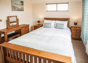 a bedroom with a large bed and a mirror at Holderness Country Park in Tunstall