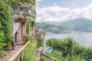 an old building on a hill next to a body of water at Villa Scarpariello Relais in Ravello