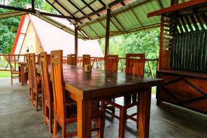 a wooden table and chairs in a pavilion at Ever Top Resort Kithulgala in Kitulgala