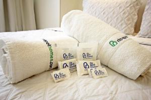 a pile of towels and towels on a bed at Rio Spot Ipanema C011 in Rio de Janeiro