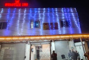 Swastiik Inn的上面有蓝色的灯的建筑