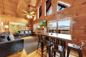 a living room with a table and chairs in a cabin at High Cotton Epic Views Hot Tub Pool Table in Sevierville