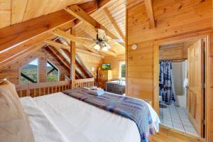 a bedroom with a bed in a wooden cabin at High Cotton Epic Views Hot Tub Pool Table in Sevierville