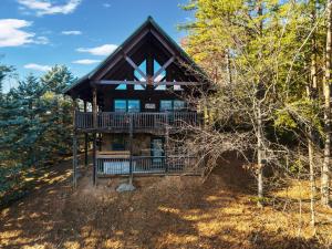a log home in the woods with a large deck at High Cotton Epic Views Hot Tub Pool Table in Sevierville
