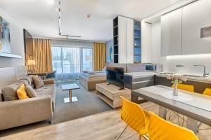 a living room with a couch and a table at TATRA SUITES Luxury Studio A302 in Starý Smokovec
