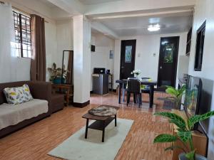 a living room with a couch and a table at Balay Degay Transient House in Baguio