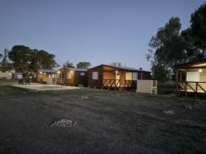 a row of lodges in a field at night at CABAÑAS BRUTUS RANCHs in Azul