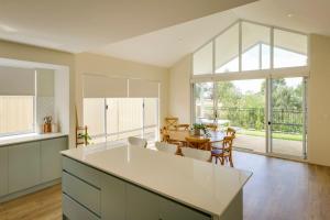 an open kitchen with a table and a dining room at Isla Escape Pet Friendly Dunsborough in Dunsborough