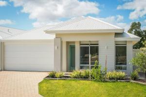 a large white house with a garage at Isla Escape Pet Friendly Dunsborough in Dunsborough