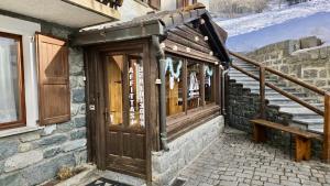 a wooden door on the side of a building at 360 Viewpoint Alpine Apartments "Mont Blanc" in Valtournenche