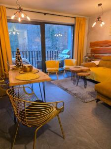 a living room with a bed and a couch at Apartament SPOKOLOKO Wiślańska Złoty B1 in Szczyrk