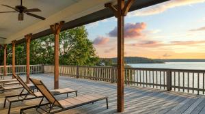 een terras met stoelen en uitzicht op het water bij Gather in Style Space Views & Comfort in Runaway Bay