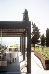 a patio with a table and chairs on a building at Borgo Capietaglio Wine Resort in Gromlongo