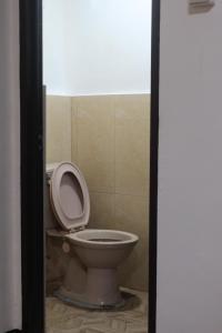 a bathroom with a toilet with the seat up at Balay Degay Transient House in Baguio +10 photos