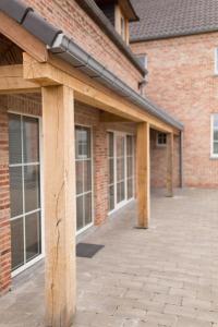 a large brick building with a patio at l'Intervalle in Mont-Saint-Guibert
