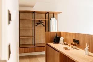 a kitchen with a wooden counter with a coffee maker at Alfred Hotel & Gastro Bar in Marche-en-Famenne