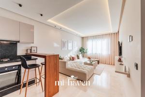 a living room with a couch and a table at Aura - 1 BR - Premium Apartment in Maarif