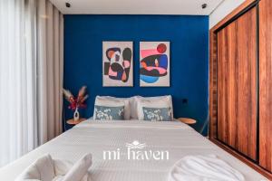 a bedroom with a bed with a blue wall at Aura - 1 BR - Premium Apartment in Maarif