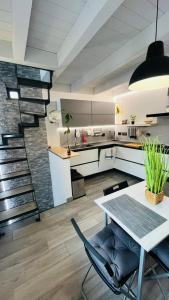 a large kitchen with a table and a staircase at Frascati Tower B&B in Frascati
