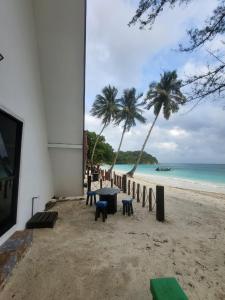 ein Tisch am Strand mit Blick auf das Meer in der Unterkunft DEWATI ROOMSTAY B&B in Lang Tengah