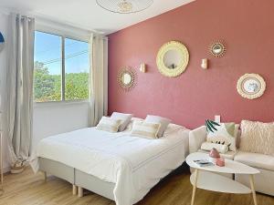 a bedroom with a bed and a couch and a window at Studio en Provence in Cheval-Blanc