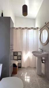 a white bathroom with a sink and a mirror at Studio en Provence in Cheval-Blanc