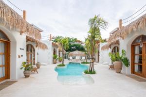an exterior view of a villa with a swimming pool at Luna Kai Villas in Uluwatu