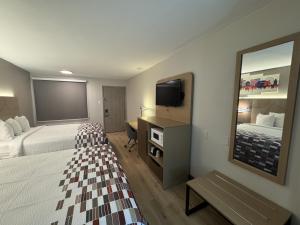 a hotel room with two beds and a mirror at Red Roof Inn Arlington - Entertainment District in Arlington