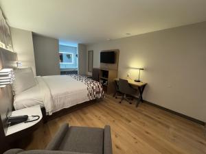 a hotel room with a bed and a desk with a computer at Red Roof Inn Arlington - Entertainment District in Arlington