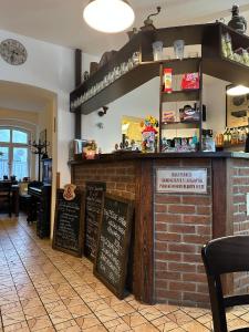 een restaurant met een bakstenen toonbank met krijtborden bij Penzion Stará škola Klíny in Klíny