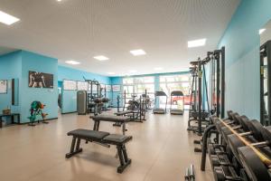 a gym with treadmills and machines in a room at HSM Hotel San Martino in Garbagnate Monastero 