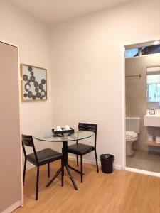 einen Tisch und Stühle in einem Zimmer mit WC in der Unterkunft Injoy Lofts & Studios Ipanema in Rio de Janeiro